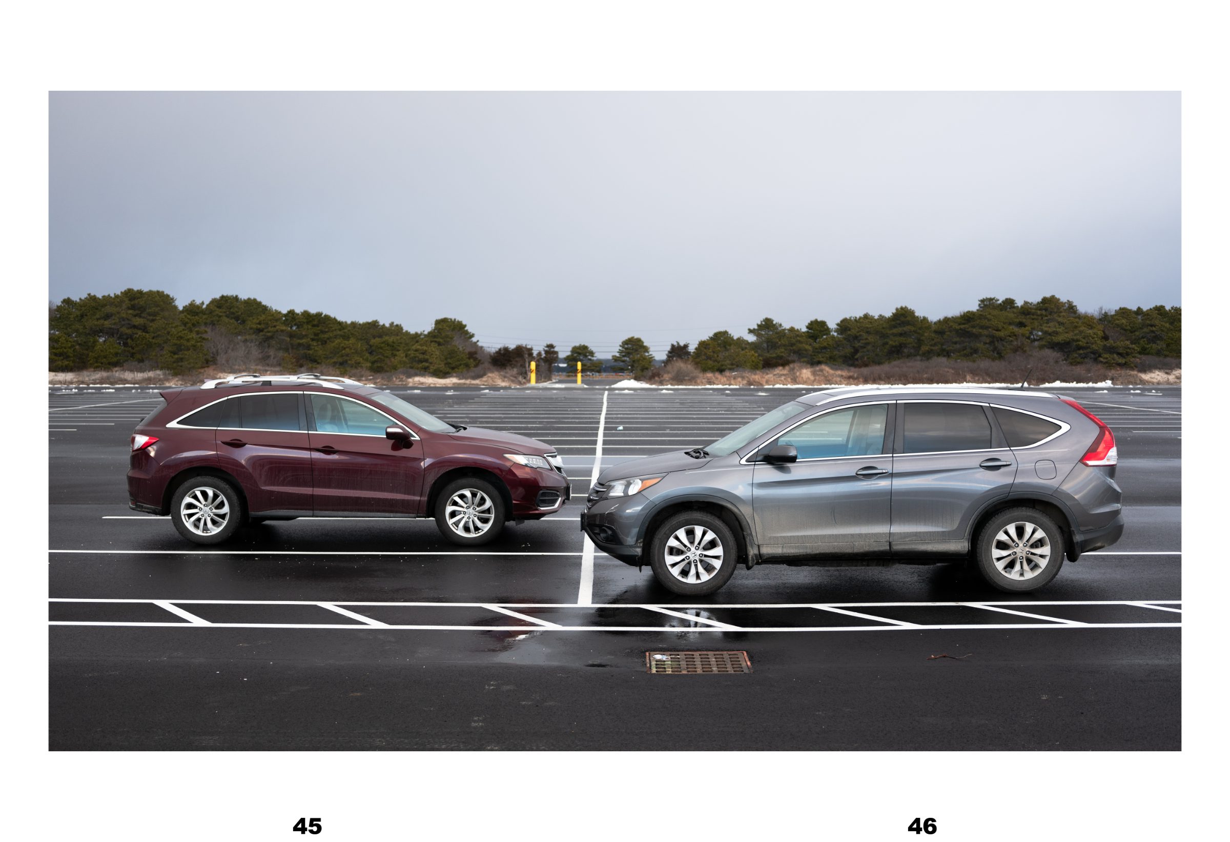 Spread: two SUVs parked nose to nose in an empty wet lot under a gray winter sky.